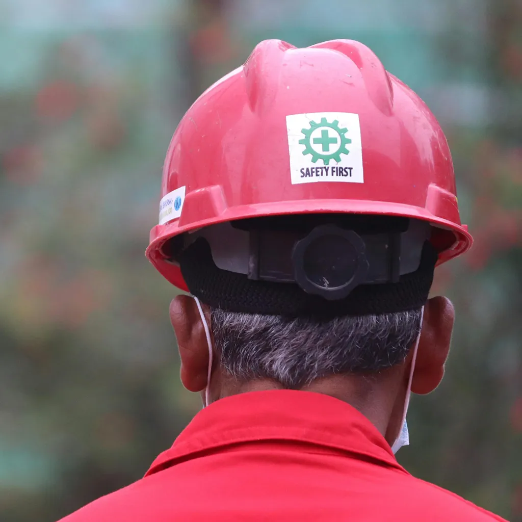 Back of a workers' hardhat which contains a safety sticker.