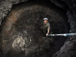 Man in a deep hole, lookig upwards