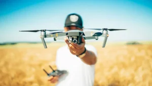 Man holding a drone in a field